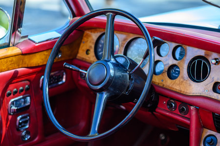 Close-up of a vintage car dashboard with wooden paneling and classic controlsの写真素材