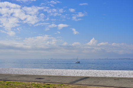 View of the Osaka Bay during sunset, with Kansai International Airport in the background, at Marble beach in Tajiri-cho, Izumisano, Osaka Prefecture of Japanの写真素材