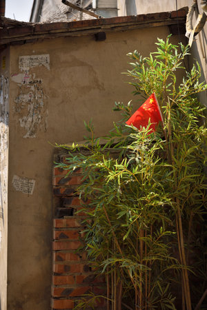 Small flag of China in traditional Hutong, narrow back alley in central Beijing, China on 21 April 2024の写真素材