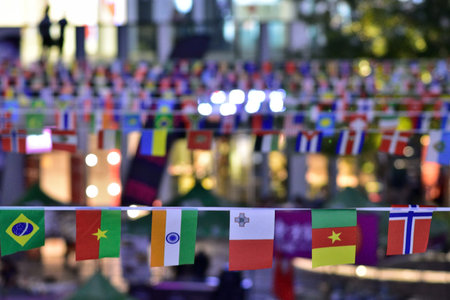 Colorful international flags hanging in a festive outdoor setting.の写真素材