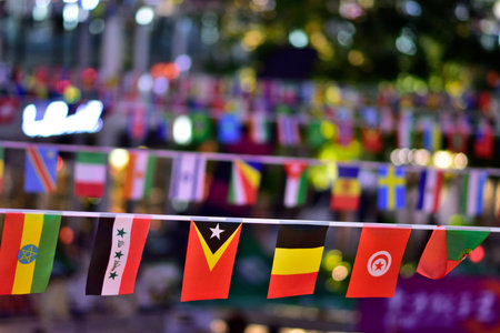 Colorful international flags hanging in a festive outdoor setting.の写真素材