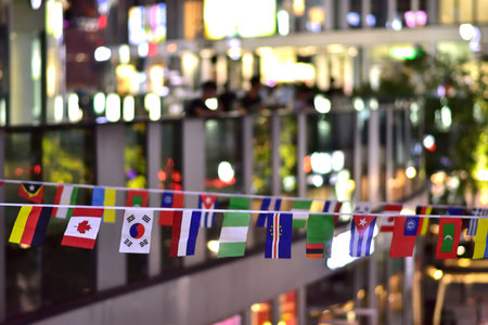 Colorful international flags hanging in a festive outdoor setting.の写真素材