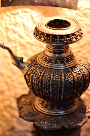 Ornate antique metal teapot with intricate engravings