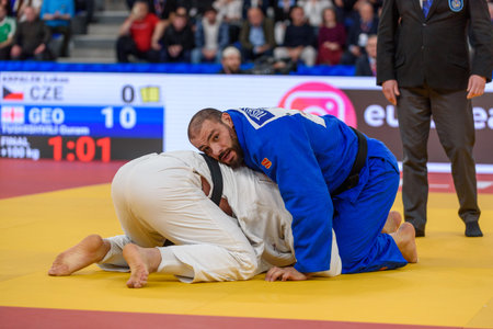 Tbilisi, Georgia. 19 April, 2026. Guram TUSHISHVILI of Georgia (blue) against Lukas KRPALEK of Czech Republic (white) in a gold medal match for Men over 100 kg at European Judo Championships Seniors Tbilisi 2026 Individuals.