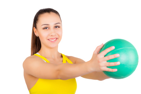 Young athletic girl. Smiling and holding a ball in handの写真素材