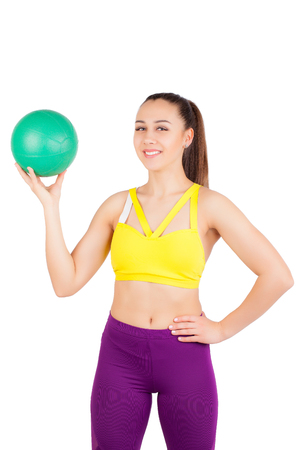 Young athletic girl. Smiling and holding a ball in handの写真素材