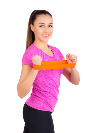 athletic girl with a gymnastic rubber band on her hands. isolated on white backgroundの写真素材