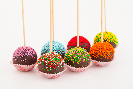 Colored cup cake on stick, on white backgroundの写真素材