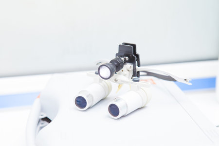 Glasses-microscope of the dentist, spectacles magnifying binocular. lies on the table