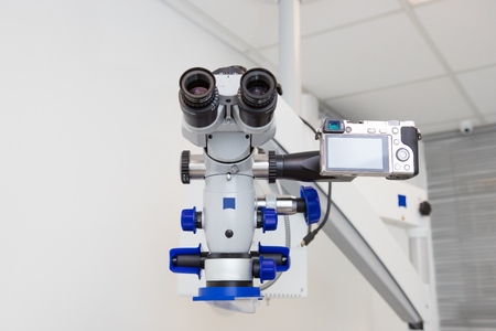 Image of a professional dental endodontic binocular microscope with a camera in the treatment roomの写真素材