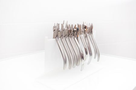 set of metal tools for the orthodontist, standing on the tableの写真素材