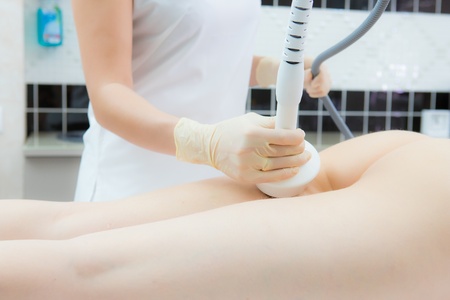 Hardware cosmetology. Woman anti-cellulite treatment at medical spa center. Woman getting anti cellulite massage in spa salon. Body contouring treatment in clinic. Beautician works in glovesの写真素材