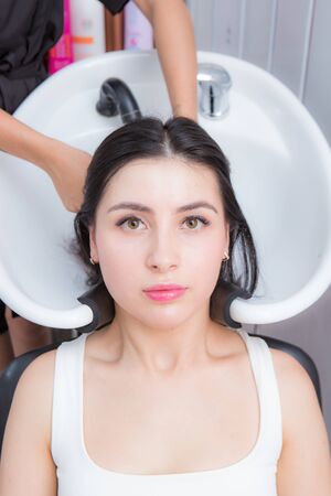 young beautiful woman wash their hair in a beauty salonの写真素材