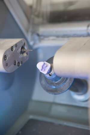 finished dental implant in the CEREC dental milling machine in the doctor's officeの写真素材