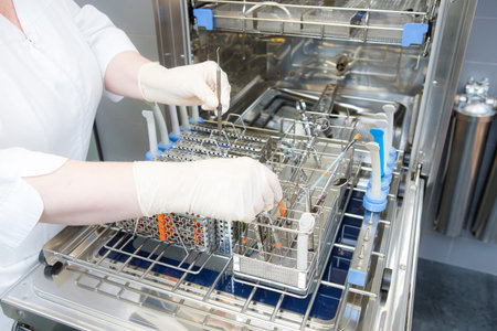 Sterilizing medical instruments in autoclave. Dental office
