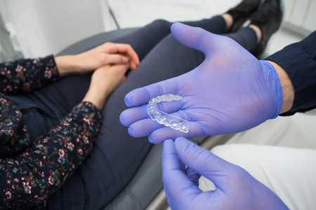 Dentist showing dental mouthguard for teeth close-up