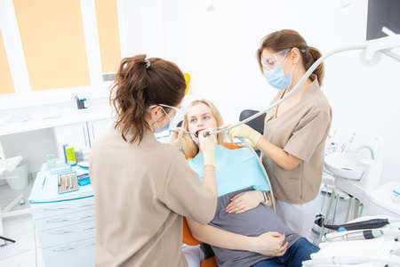 pregnant woman at the dentists office, checkup and dental treatment for pregnant women.の写真素材