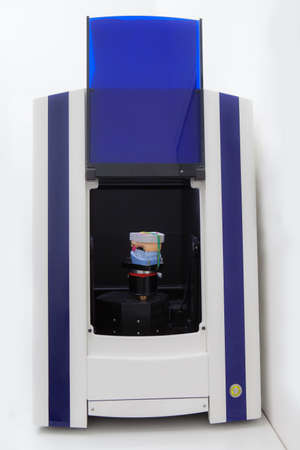 Open dental 3d scanner in a dental laboratory, with a jaw model insideの写真素材