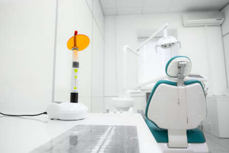 Dental polymerization lamp with UV light and laser. Stomatological instrument in the dentist clinic. Medicine, health, stomatology conceptの写真素材
