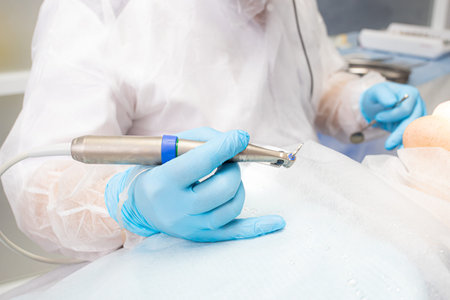 the dentist holds the instrument during the dental implant surgeryの写真素材