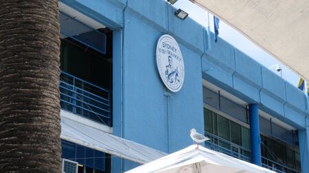 Sidney fish market logo on the blue wall. World's second largest fish market after Tokyo. Tasty and healthy food.のeditorial素材