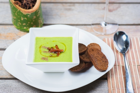 vegetarian vegetable soup with bamboo shoots in a bowl on a wooden tableの写真素材