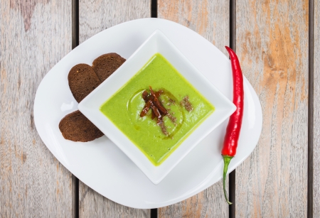 vegetarian vegetable soup with bamboo shoots in a bowl on a wooden tableの写真素材
