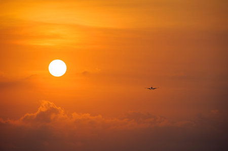 Silhouette of the big plane on a sunset backgroundの写真素材