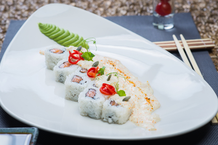 Roll set served on a plate on a table in a restaurantの写真素材