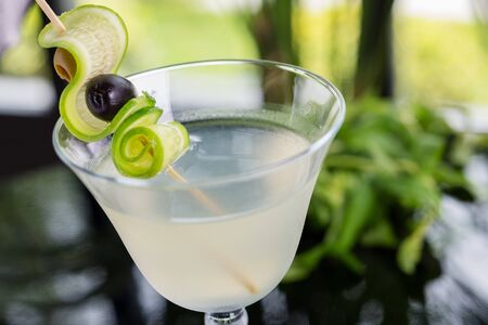 bright glasses with cold alcoholic cocktail on a table in a restaurant with creative decoration. soft focusの写真素材