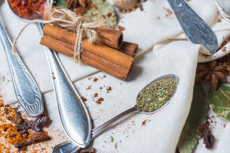 mix of different spices and herbs on a table with decorの写真素材