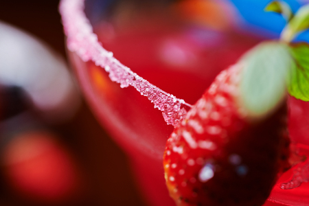 extremely close up of  bright refreshing cocktails: strawberry daiquiri on a table in a restaurant with creative decoration of salt on the edge of the glass with berries. soft focusの写真素材