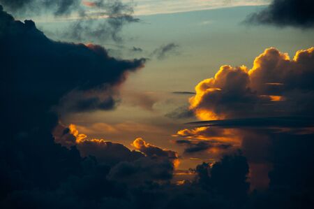 Colorful huge clouds a blue sky background at sunset. Magnificent tropical sunset colors clouds in magical colors.の写真素材