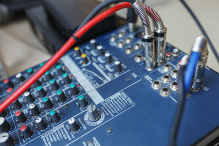 DJ mixer for sound effects and acoustic systems connection. Connected audio cables to a special...
