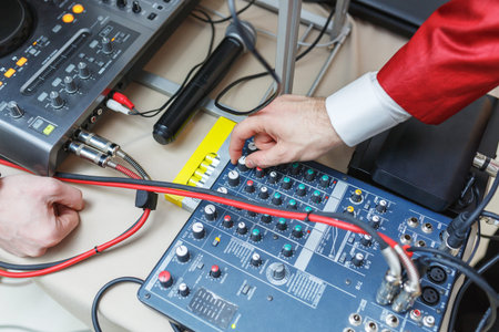 Musician adjusts audio equipment. Man sets the audio level on the console audio effects. Male hand...