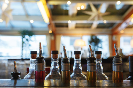 a few bottles on the bar barman prepared for making alcoholic drinks during a party at a nightclub, a restaurant or cafe. bar in a nightclub with a bright backgrounds.の写真素材