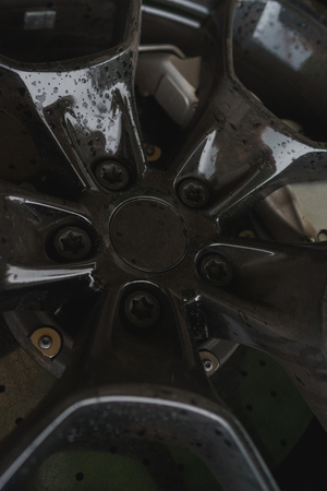 Stylish and expensive sports car closeup.  Black stylish sportcar alloy wheels with sports tires closeupの写真素材