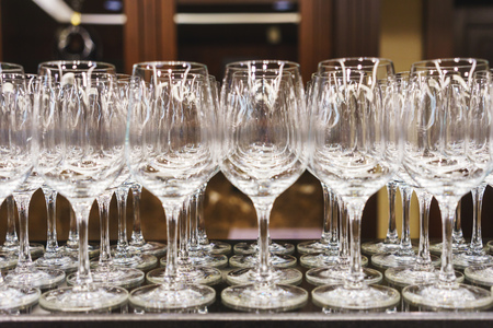 Several of clean wine glasses exposed bartender on the bar during the event. Service catering at events and festivals. Clean utensils for drinks at the reception.の写真素材