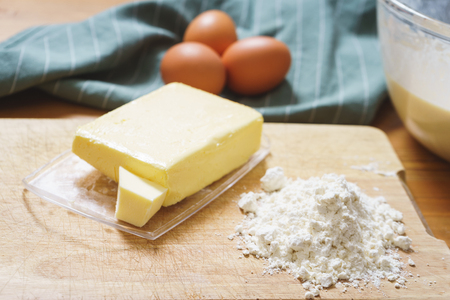 Top view of the dough and ingredients for making traditional thin pancakes. The process of making pancakes on an ordinary kitchen. Crockery and kitchen utensils. Soft focus.の写真素材