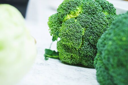 Pure fresh broccoli prepared for cooking vegetarian dishes in the kitchen. Fresh vegetables for healthy eating. Preparation and cooking of healthy food. Soft focus.の写真素材