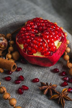 Juicy aromatic pomegranate on the table with a decor. Soft focus and beautiful bokeh.の写真素材