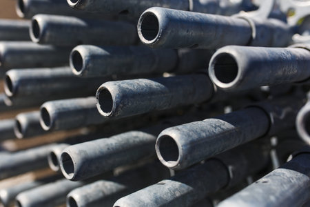 metal structures in a warehouse in stacks. metal supports for scaffolding and formwork. soft focus...