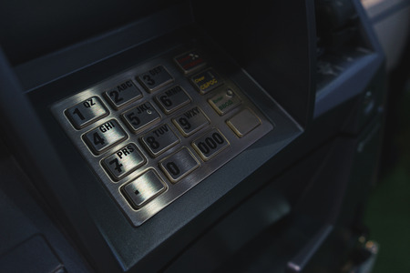 ATM keyboard close-up. Banking and banking, credit cards and cash in ATM. Soft focus and beautiful bokeh.の写真素材
