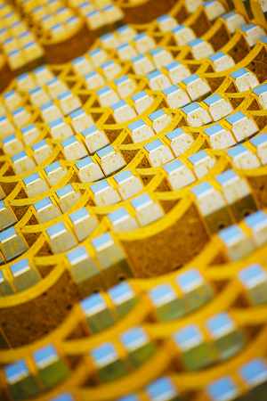 New yellow wooden formwork stacked in a warehouse in large piles. Materials for the construction and erection of concrete structures. Abstract background, soft focus and beautiful bokeh.の写真素材
