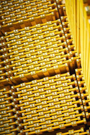 New yellow wooden formwork stacked in a warehouse in large piles. Materials for the construction and...