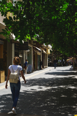 Heraklion, Greece, April 2018. Streets of Heraklion. Warm, sunny day in a Greek city. Walk around the city on a summer day. Souvenir shops and attractions of the ancient city.のeditorial素材