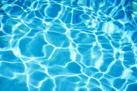 Clean water surface in the pool with small waves and blur. Beautiful color and refreshing coolness....