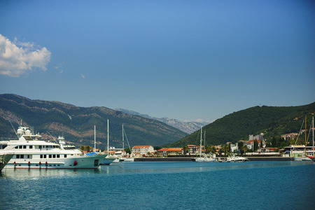 Beautiful vacation wallpaper. Luxury sea yachts moored on the pier. Beautiful seascape on the background of mountains. Journey to the Mediterranean.の写真素材