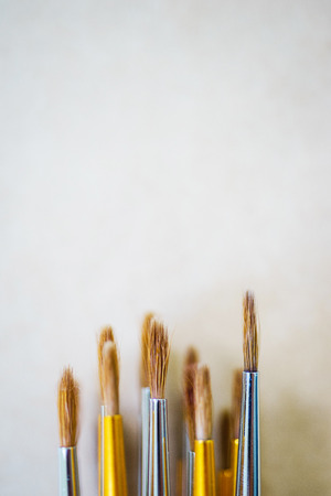 View from above of the artist's brush and tools prepared for work with copy space. Top view of artist's tools. Brushes prepared for drawing on canvas and paper. Concept for art school wallpaper.の写真素材