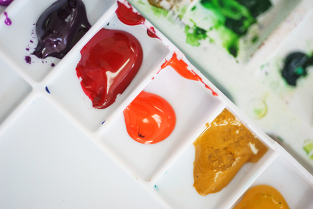 Details of the creative process of the artist, a a watercolor palette with paints. Art education and art. Soft focus and beautiful bokeh.の写真素材